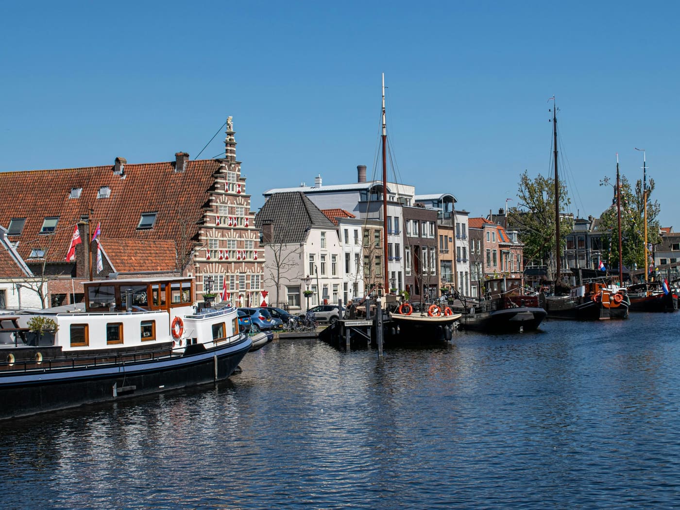 Historische schepen en grachtenpanden aan het water in de Leidse binnenstad